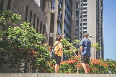 Teens talking in the city. boys enjoying vacation, skyscrapers in metropolis, explore new country