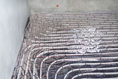 White pipes of underfloor heating systems, distributed in an individual family house on  foil.