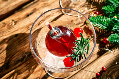 Christmas drink mimosa, punch or cranberry margarita cocktail serving in christmas ornaments