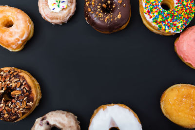 Directly above shot of cupcakes against black background