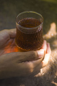 Close-up of hand holding drink