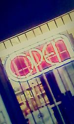 Low angle view of signboard against blue sky