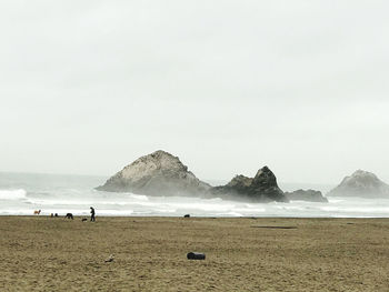 Scenic view of beach against clear sky