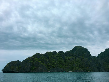 Scenic view of sea and mountains against sky