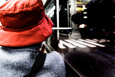 Close-up of man standing by red umbrella