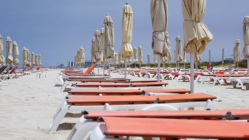 Panoramic view of lounge chairs on beach