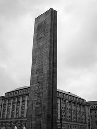 Low angle view of building against cloudy sky