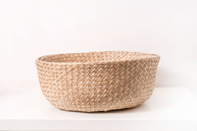 Close-up of wicker basket over white background