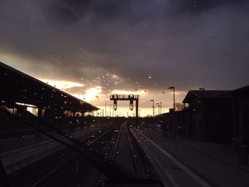 Railroad track against cloudy sky