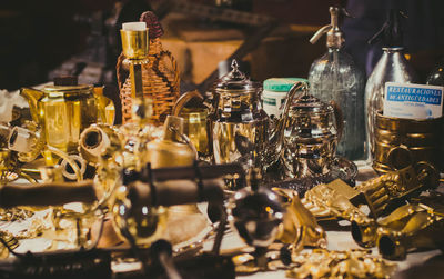 Close-up of antique objects on table for sale in store