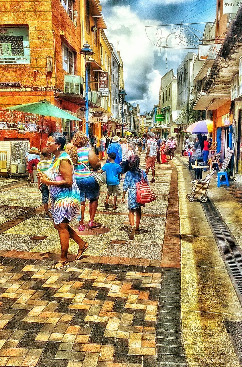 building exterior, architecture, built structure, lifestyles, leisure activity, city, sky, city life, the way forward, day, market, outdoors, residential building, casual clothing, building, town, market stall, cloud - sky