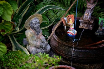 Close-up of buddha statue against plants