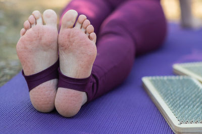 Low section of woman sitting on table