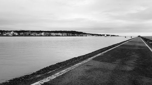 Scenic view of river against sky in city