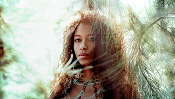 CLOSE-UP PORTRAIT OF YOUNG WOMAN WITH TREE