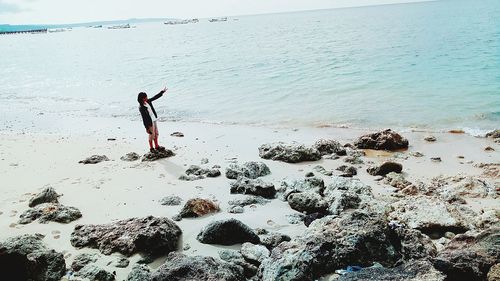 Man standing on beach against sky