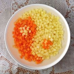 High angle view of chopped fruits in bowl on table