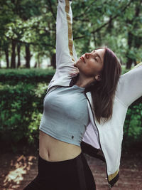 Midsection of woman with arms raised