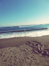 Scenic view of beach against clear sky