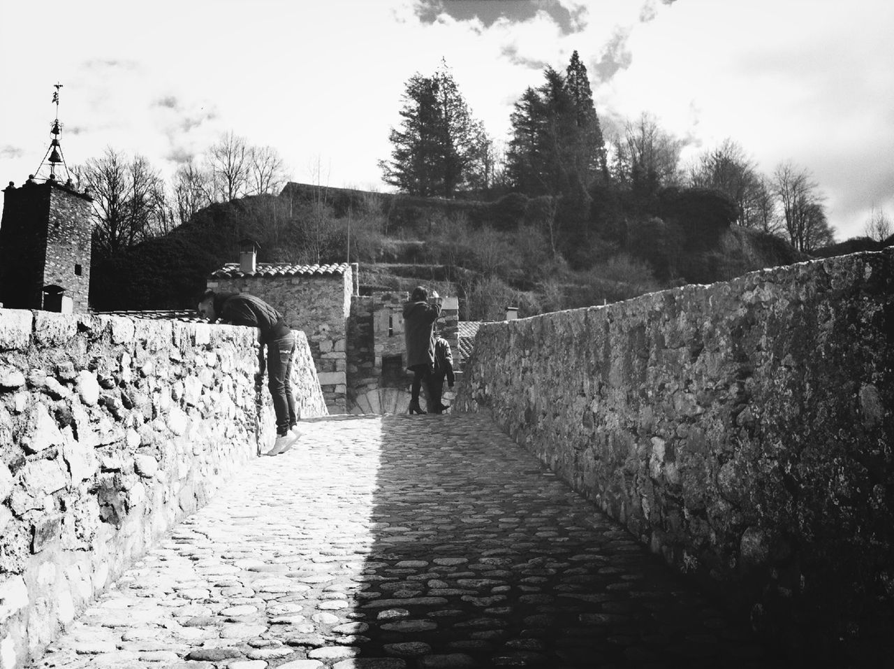 the way forward, architecture, built structure, sky, diminishing perspective, cobblestone, rear view, walking, building exterior, men, footpath, vanishing point, full length, lifestyles, pathway, stone wall, walkway, person