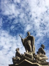 Low angle view of statue against cloudy sky