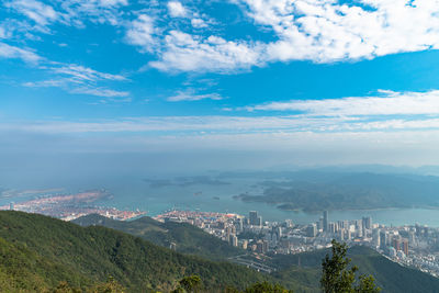 Aerial view of city and mountains against sky