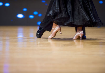 Low section of couple dancing on floor