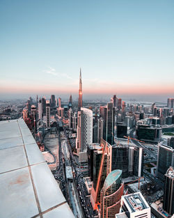 Aerial view of buildings in city during sunset