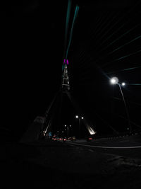 View of illuminated tower against clear sky at night