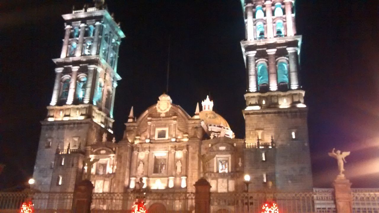 architecture, building exterior, built structure, night, low angle view, illuminated, church, religion, place of worship, spirituality, city, cathedral, famous place, travel destinations, sky, facade, window, history