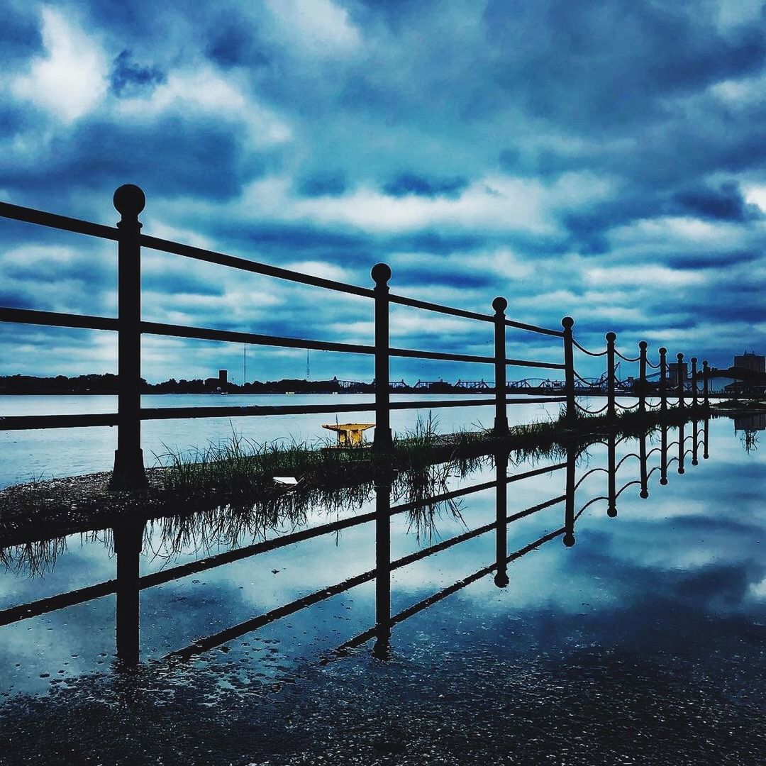 PIER AMIDST SEA AGAINST SKY