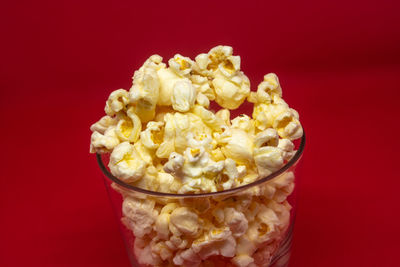 High angle view of ice cream in bowl against red background