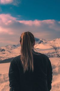 Close-up of woman standing against sky during sunset