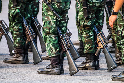 Low section of army soldiers standing on road