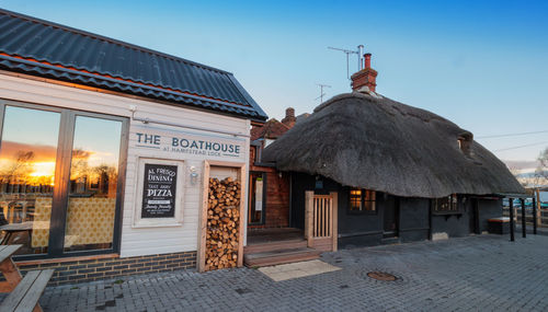 Houses by street against sky in city