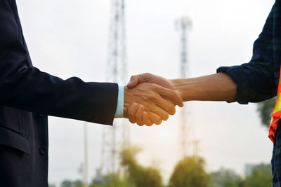 Close-up of hand holding hands against blurred background