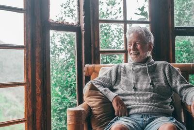 Man sitting on chair at home