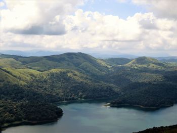 Scenic view of lake and mountains against sky