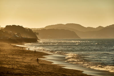 Scenic view of sea against clear sky during sunrise