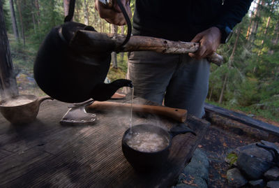 Low section of man working on log