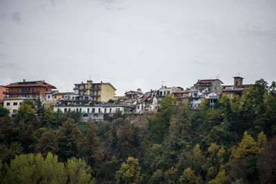 High angle view of trees and buildings against sky