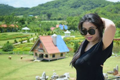 Young woman in sunglasses on field