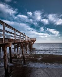 Pier over sea against sky