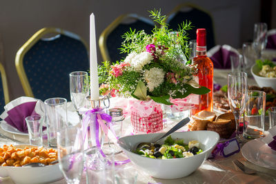 Close-up of bouquet with food and place setting on table