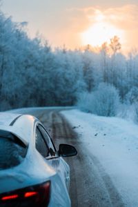 Woman standing on snow covered road