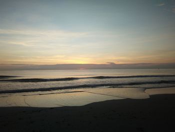 Scenic view of beach against sky during sunset