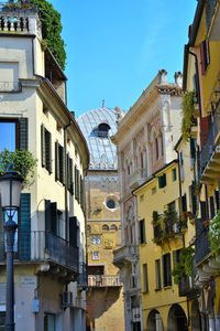 Low angle view of buildings against blue sky