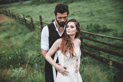 Portrait of young couple standing outdoors