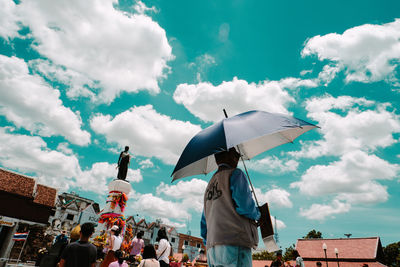 Low angle view of buildings against cloudy sky