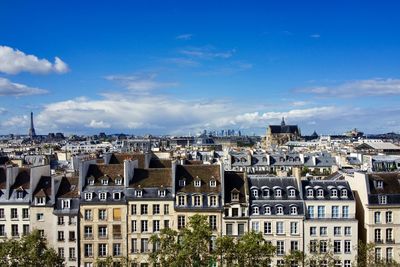 Above the roofs of paris, france - eiffel tower and la defense in the far background